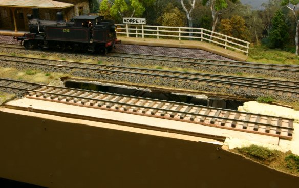 This photo shows the gap in the scenery where the engine shed once stood. I've installed a short length of track here to extend the siding and this is now wired up so I can move onto filling the gaps. 
